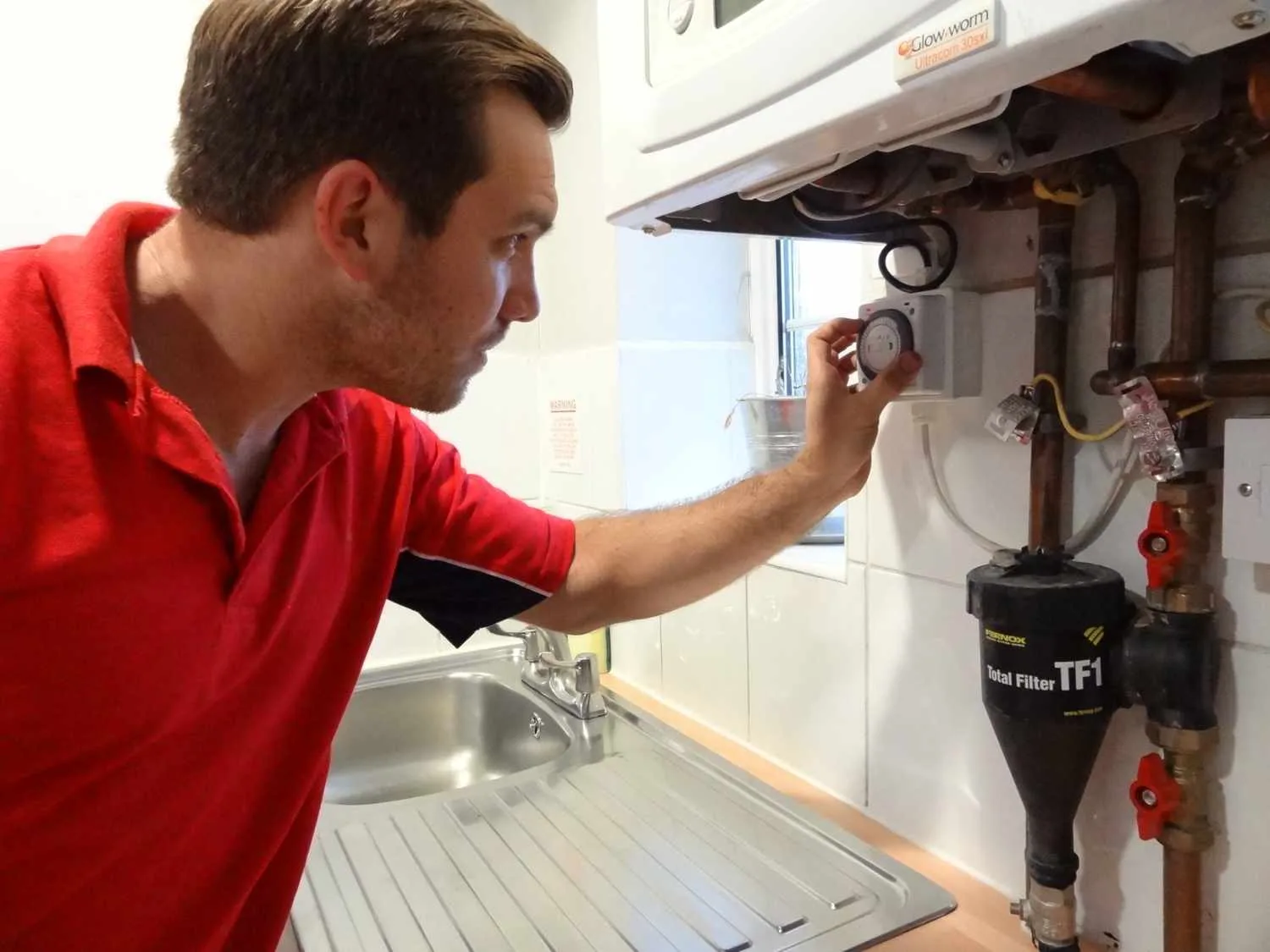 Sunbury Plumbers boiler repair engineer working on a boiler in Sunbury-on-Thames